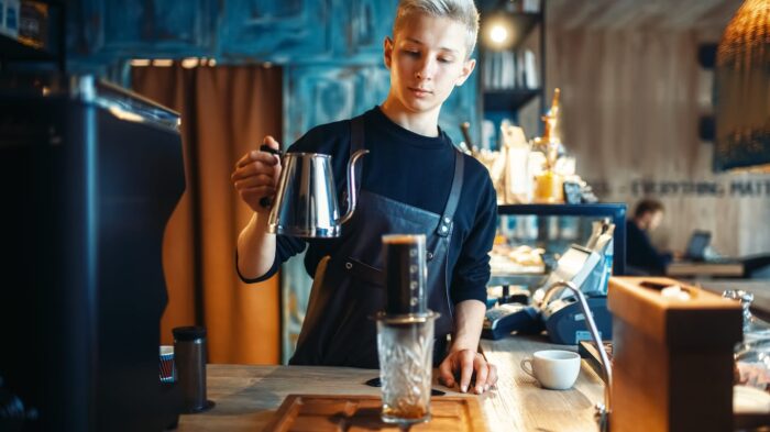 Barista Pours Water From Coffee Pot